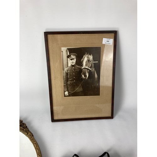 293 - Three items, two vintage wall mirrors and one mahogany framed black and white photograph of a soldie... 