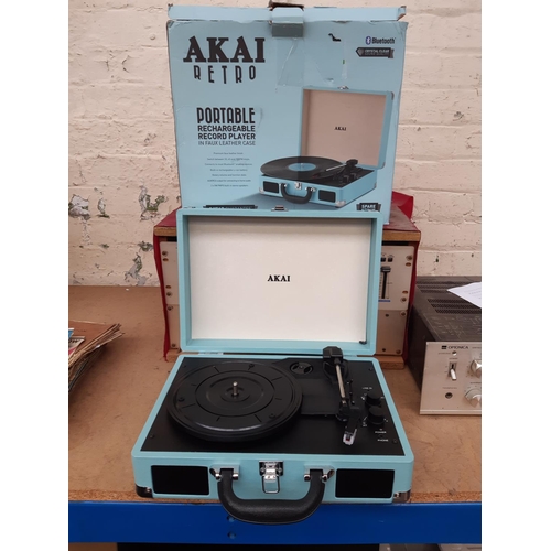 1027 - A boxed Akai Retro portable rechargeable record player with bluetooth in blue faux leather case