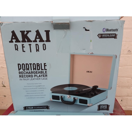 1027 - A boxed Akai Retro portable rechargeable record player with bluetooth in blue faux leather case