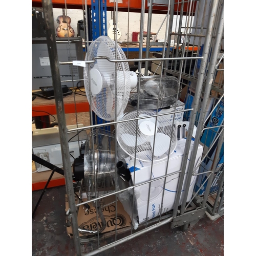 1041 - A cage containing a large quantity of shop return boxed and unboxed fans, brands to include Mistral,... 