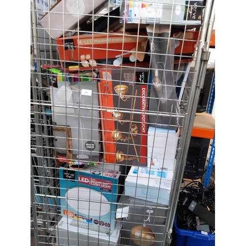 1043 - A cage containing a large quantity of shop return boxed and unboxed lighting products, brands to inc... 