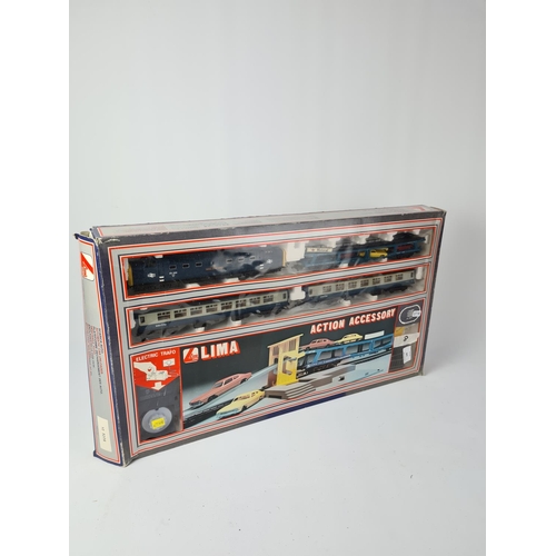 226 - A boxed vintage Lima OO gauge train and action accessory set