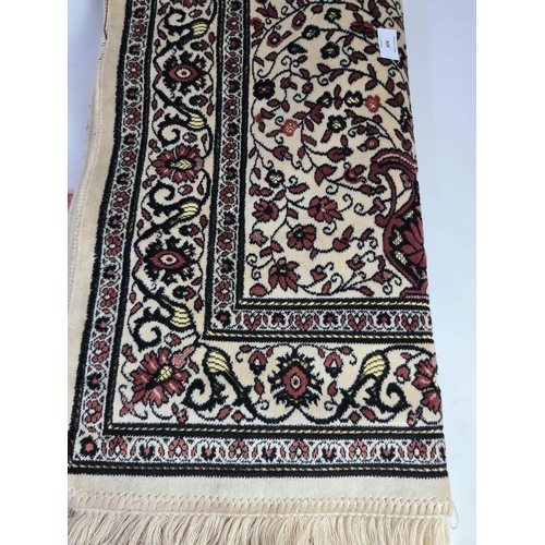 308 - Two vintage Kadifeteks Turkish rugs - beige rug approx. 106cm x 66cm and turquoise rug approx. 110cm... 