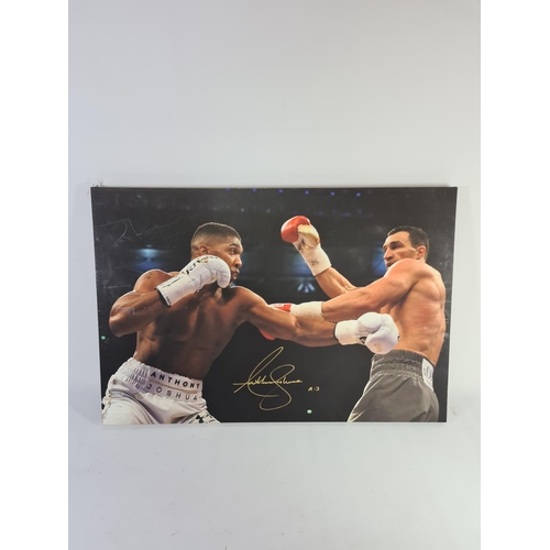 340 - A signed Anthony Joshua vs Wladimir Klitschko print on canvas - approx. 77cm x 52cm