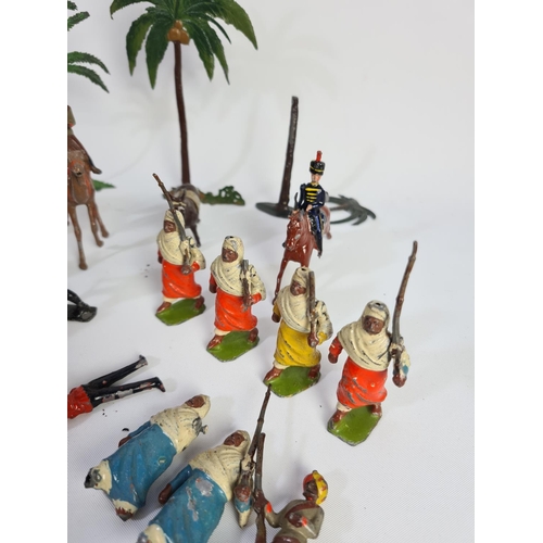 239 - A collection of vintage lead figurines and accessories to include some Britains