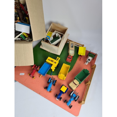 242 - A collection of various toys to include wooden farm yard, Dinky Massey Harris tractor, animals, Matc... 