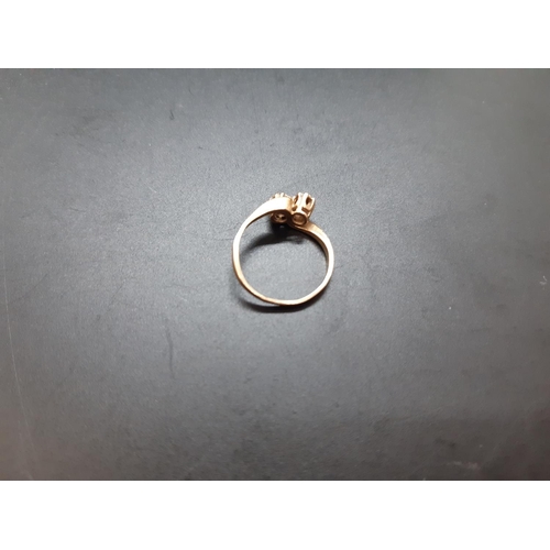 16 - A stamped 9ct gold ladies ring with two inset CZ stones - size J and approx. total weight 1.3 grams