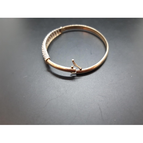 34 - A hallmarked 9ct gold ladies bangle with inset CZ stones - approx. total weight 6.29 grams