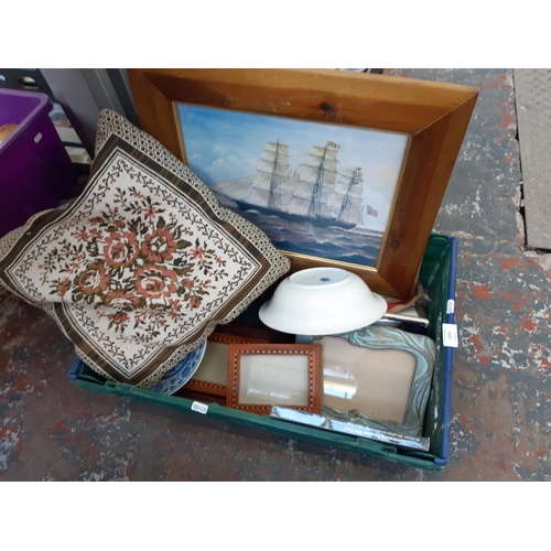 1373 - A box containing Abbey blue and white jug, John Tams Ltd. blue and white bowl, framed pictures, cush... 