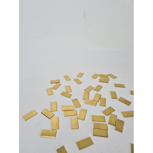 59 - Fifty 22ct gold tooth caps/grills - approx. weight 100 grams