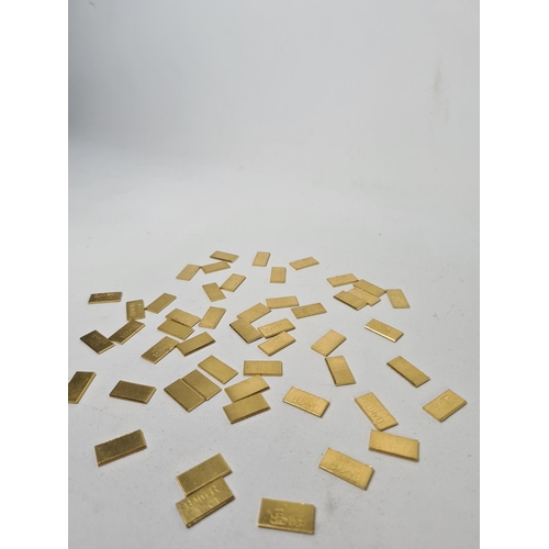 59 - Fifty 22ct gold tooth caps/grills - approx. weight 100 grams