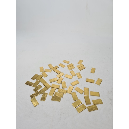 60 - Fifty 22ct gold tooth caps/grills - approx. weight 100 grams