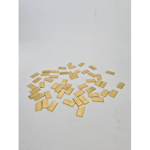 61 - Fifty 22ct gold tooth caps/grills - approx. weight 99.64 grams