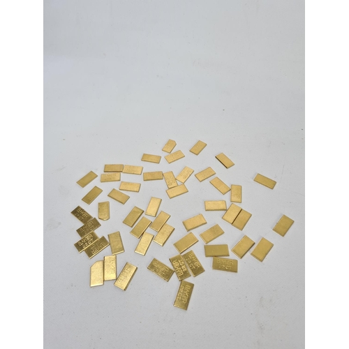 61 - Fifty 22ct gold tooth caps/grills - approx. weight 99.64 grams