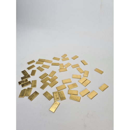 61 - Fifty 22ct gold tooth caps/grills - approx. weight 99.64 grams