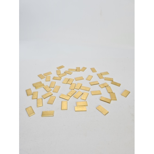 63 - Fifty 22ct gold tooth caps/grills - approx. weight 100 grams