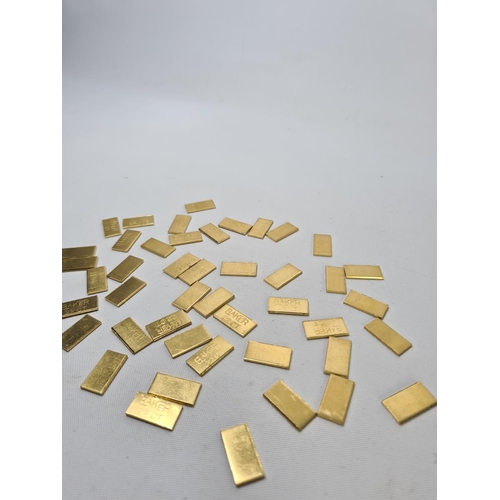 63 - Fifty 22ct gold tooth caps/grills - approx. weight 100 grams