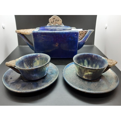103 - A Leon Leyritz of France blue studio pottery five piece tea set comprising teapot, two cups and two ... 