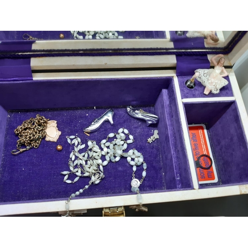 94 - A jewellery box containing costume jewellery, a boxed vintage Chanel No. 5 perfume, Sekonda nurses w... 