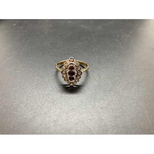 67 - A hallmarked 9ct gold garnet and diamond ladies ring - size S ½, approx. gross weight 3 grams