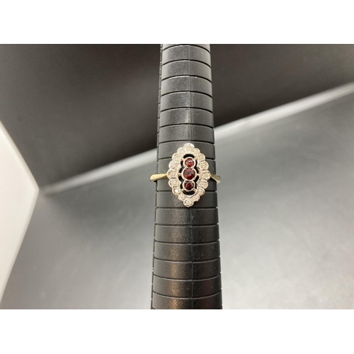 67 - A hallmarked 9ct gold garnet and diamond ladies ring - size S ½, approx. gross weight 3 grams