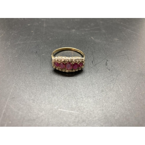 68 - A hallmarked 18ct gold ruby and diamond ladies ring with five central rubies and twenty two surround... 