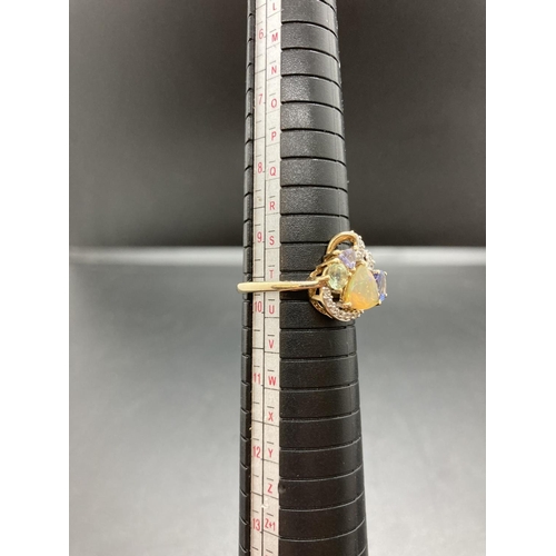 80 - A hallmarked 9ct gold ladies ring with fourteen small inset diamonds, four further stones and stampe... 