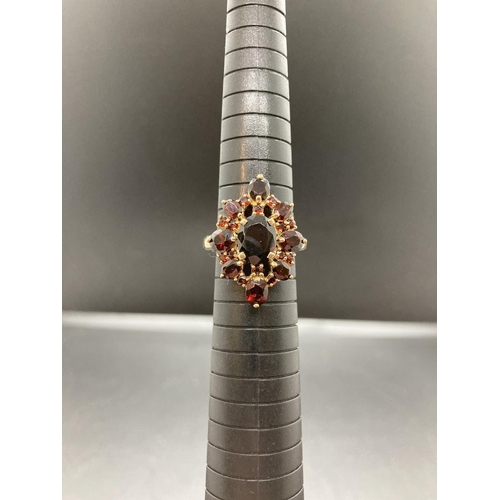 90 - A hallmarked 9ct gold and garnet ladies ring - size P ½, gross weight 4.9 grams