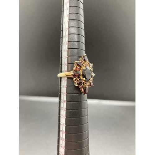 90 - A hallmarked 9ct gold and garnet ladies ring - size P ½, gross weight 4.9 grams