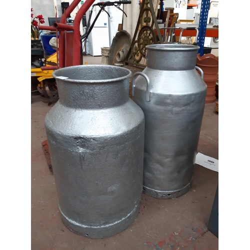 1295 - Two silver painted metal milk churns