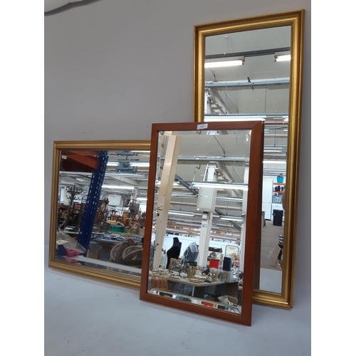 1323 - Three various mirrors to include two rectangular gilt framed and one 1970s teak framed with bevelled... 