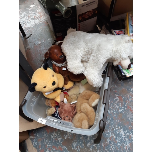 1329 - A large box of soft toys to include Sooty, Yogi Bear, Pudsey Bear etc.