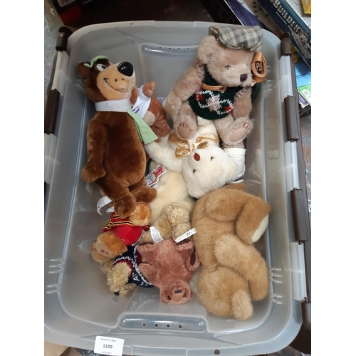 1329 - A large box of soft toys to include Sooty, Yogi Bear, Pudsey Bear etc.