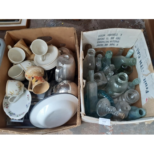 1339 - Three boxes containing vintage glass bottles, stainless steel tea set, enamel bowls, Queen Anne chin... 