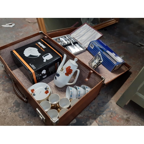 1366 - A brown leather suitcase containing Britannia coffee cups and saucers, boxed Kenwood electric knife,... 