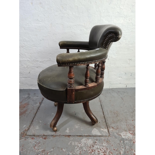 453 - A Victorian green leather and mahogany captains desk chair on castors - approx. 88cm high x 68cm wid... 
