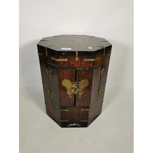 315 - A Korean elm octagonal cabinet with two doors and brass fittings - approx. 43cm high x 34cm wide x 3... 