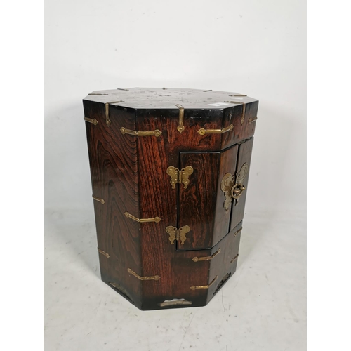 315 - A Korean elm octagonal cabinet with two doors and brass fittings - approx. 43cm high x 34cm wide x 3... 