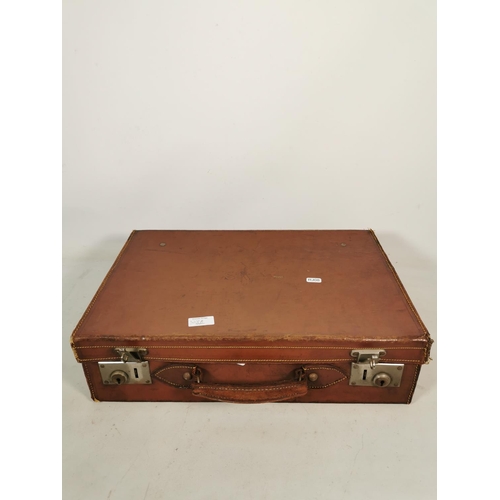 328A - A vintage brown leather suitcase