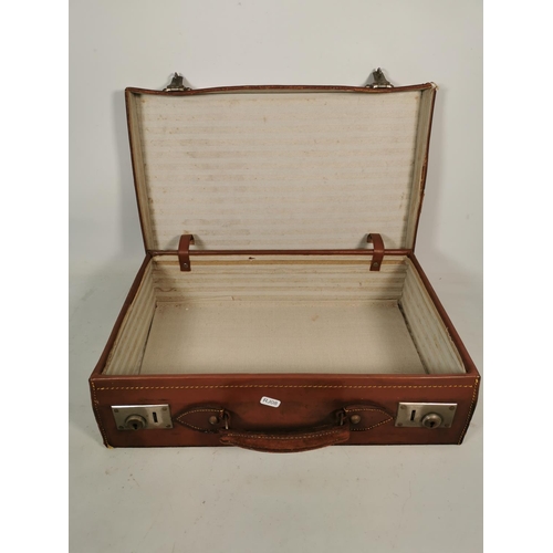 328A - A vintage brown leather suitcase