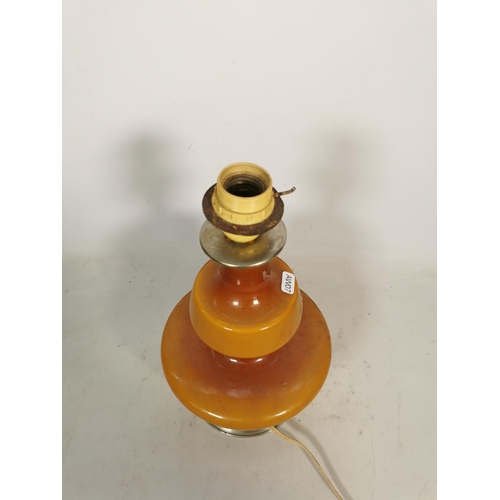 353 - A mid 20th century amber glass table lamp - approx. 29cm high