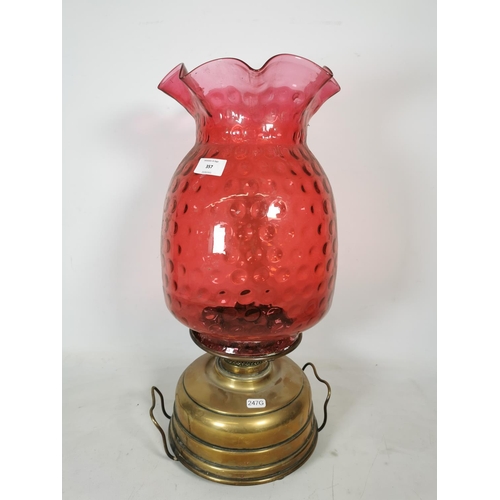 357 - A Veritas brass oil lamp with cranberry glass shade - approx. 55cm high