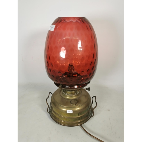 358 - A Veritas brass electric converted oil lamp with cranberry glass shade - approx. 47cm high