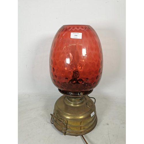 358 - A Veritas brass electric converted oil lamp with cranberry glass shade - approx. 47cm high