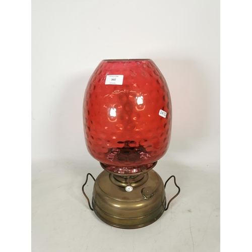 360 - A Veritas brass oil lamp with cranberry glass shade - approx. 44cm high