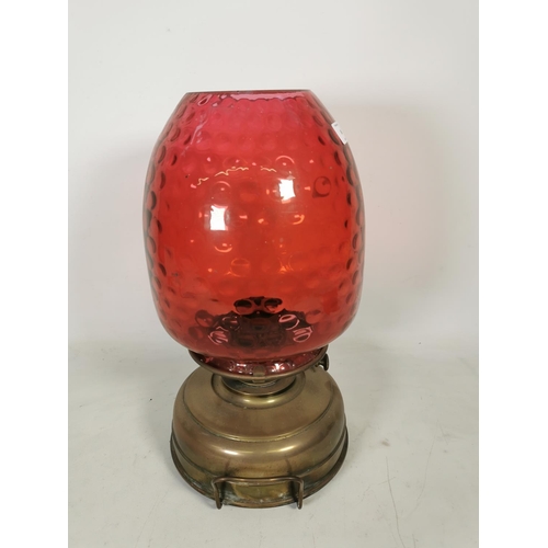 360 - A Veritas brass oil lamp with cranberry glass shade - approx. 44cm high