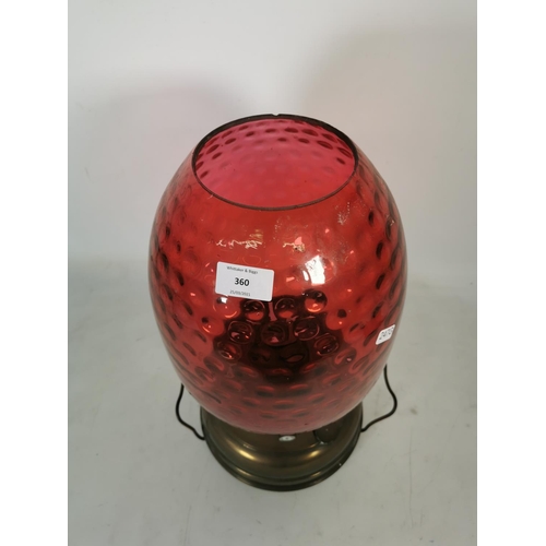 360 - A Veritas brass oil lamp with cranberry glass shade - approx. 44cm high