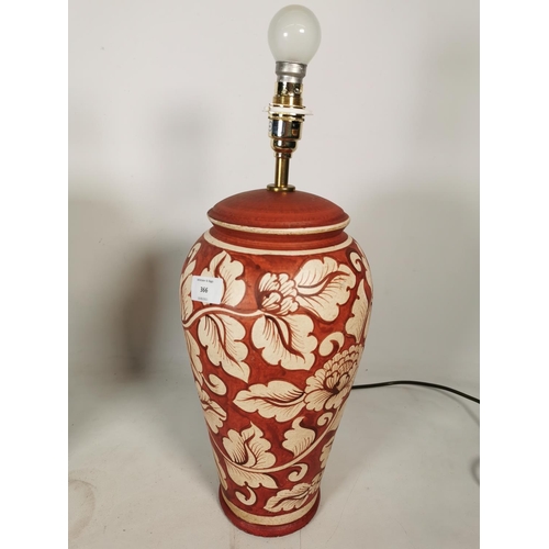 366 - A pair of Aimbry red painted ceramic table lamps with floral design - approx. 44cm high without bulb