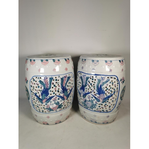 370 - A pair of oriental ceramic garden barrel seats with stylized bird design - approx. 46cm high