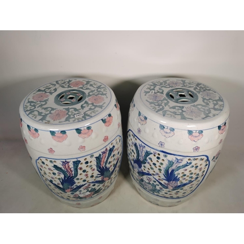 370 - A pair of oriental ceramic garden barrel seats with stylized bird design - approx. 46cm high